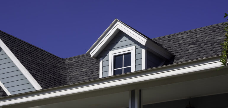 Patterson Roofing white vintage windows little room decoration roof big wooden house pastel green color blue sky background view from outside